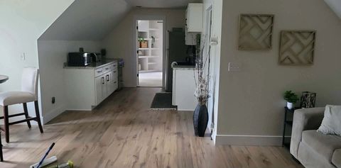 Finished wood-look vinyl plank floor running from the kitchenette into the sitting area
