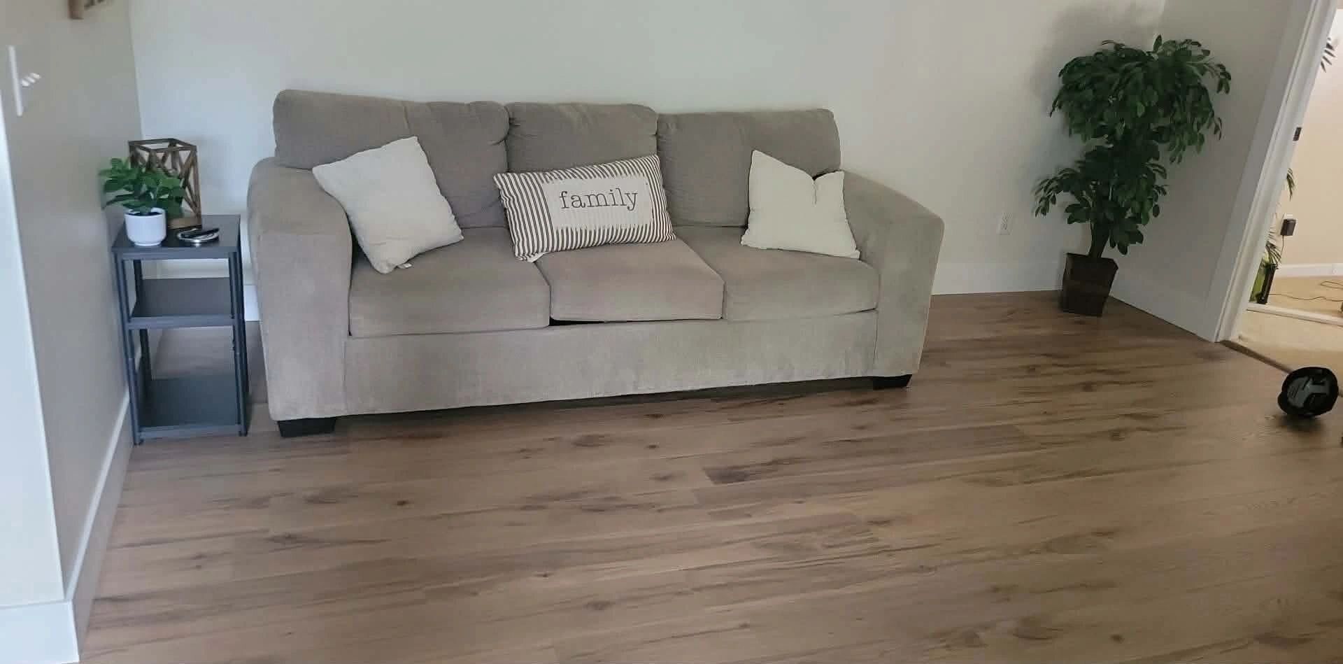 Bright living room with newly installed wood-look vinyl plank flooring, Howard City
