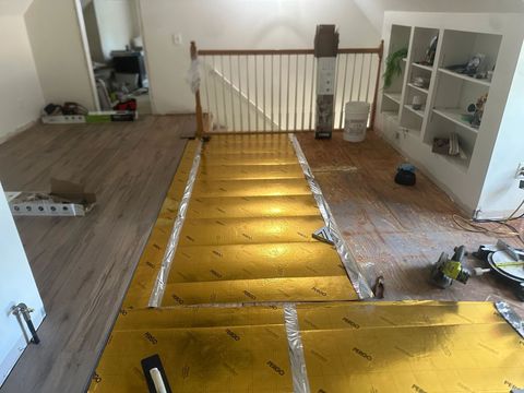 Underlayment laid across a stair landing ready for vinyl plank flooring
