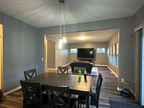Freshly painted gray dining and living area with crisp white trim