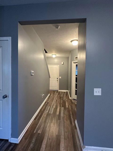 Long hallway painted in a deep blue-gray