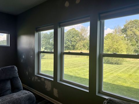 Dark wall around a row of windows spot-patched before painting