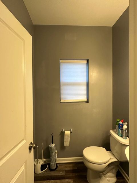 Half bathroom repainted in a medium gray